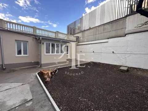 Small courtyard in front of the building with a dirt surface. - image 2