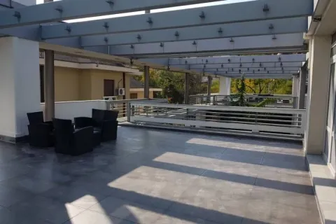 Large terrace with seating furniture and a wooden pergola. - image 3