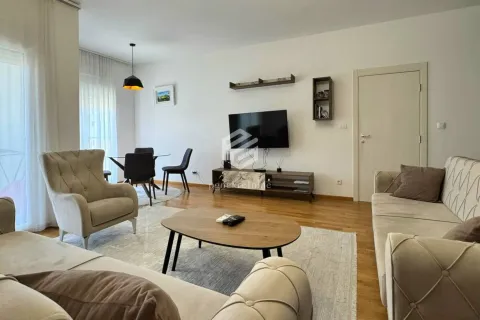 Spacious living room with sofa set, TV, and dining area. - image 2