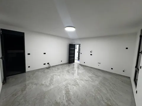 Empty room with light floor tiles and white walls. - image 14