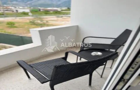Small furnished balcony with a view of the surroundings. - image 10