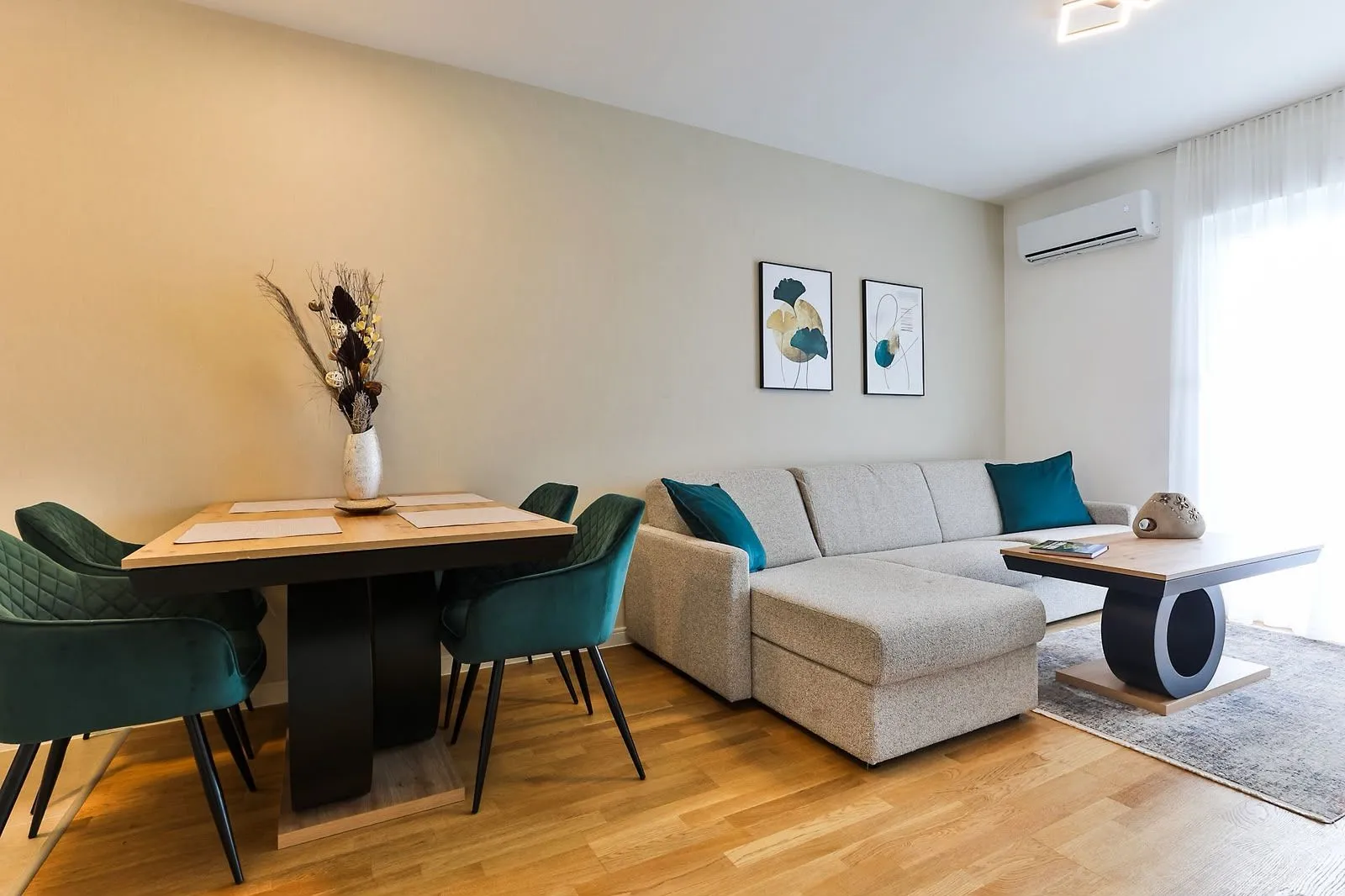 Living room with a sofa, dining table, and chairs.