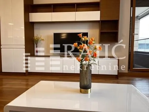 Living room with modern furniture and a TV unit.
