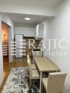 Dining area with kitchen and white cabinetry. - image 5