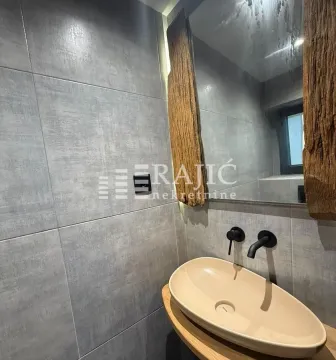 Modern bathroom with a sink and a large mirror. - image 10