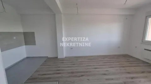 Empty room with laminate flooring and white walls. - image 3