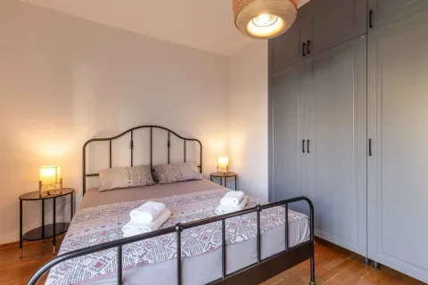 Bedroom with a double bed, bedside tables, and a large built-in wardrobe. - image 11