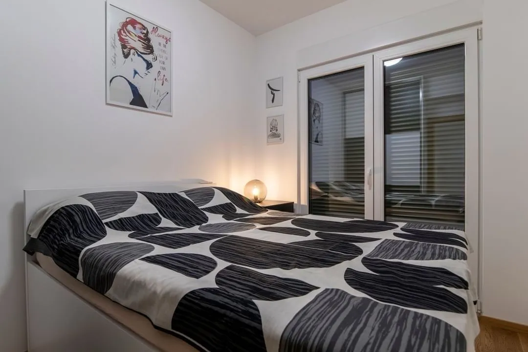 Bright bedroom featuring a double bed and decorative wall art.