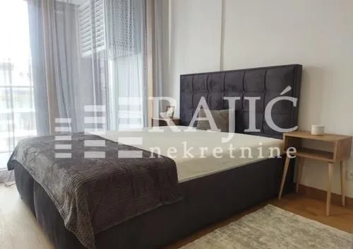 A bedroom with a double bed and bedside tables.