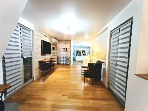 Spacious living room with wooden flooring and recessed lighting. - image 2