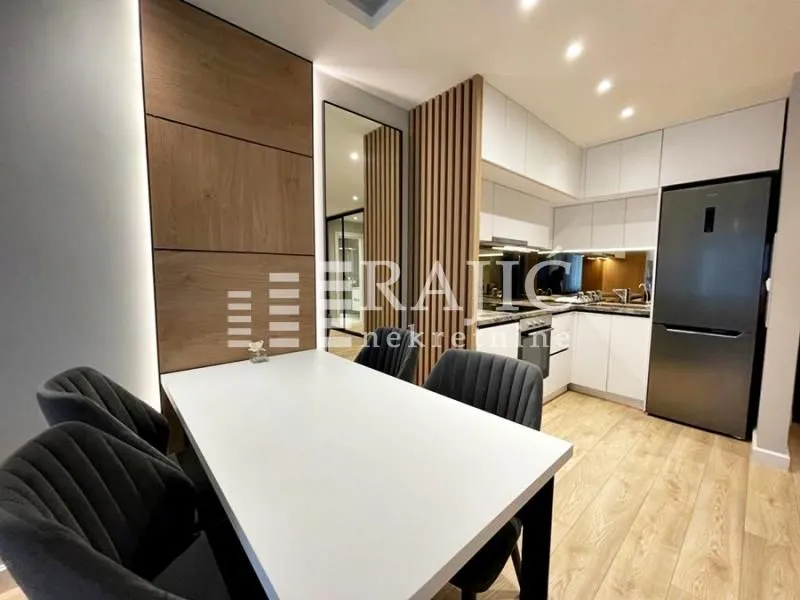 Modern kitchen with a dining area and built-in appliances.
