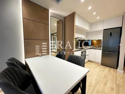 Modern kitchen with a dining area and built-in appliances. - image 3
