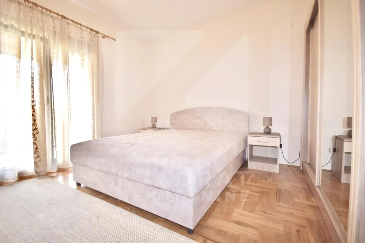Bedroom with a double bed, bedside tables, and a large wardrobe.