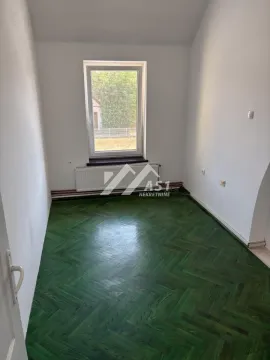 Empty room with green parquet flooring and a window. - image 9