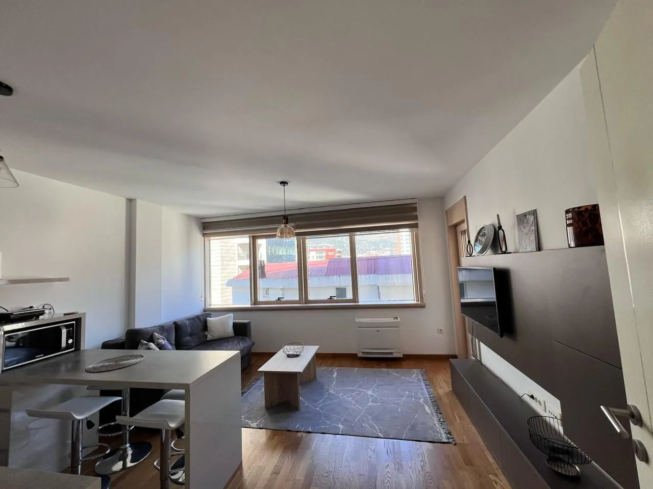 Living room connected with kitchen and dining area.