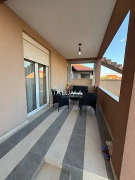 Covered terrace with outdoor seating furniture. - image 2