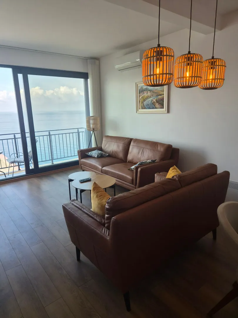 Living room with furniture and sea view.