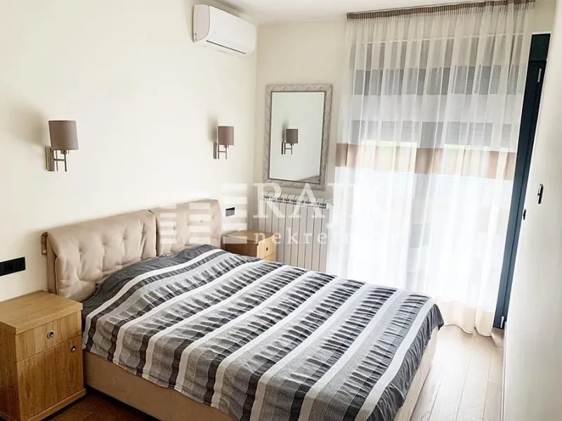 Furnished bedroom with a double bed, nightstands, and a window.