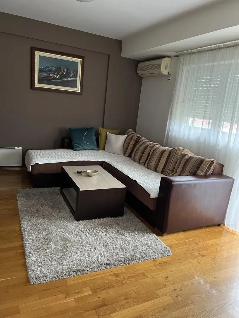 Bright living room with a corner sofa and a coffee table.