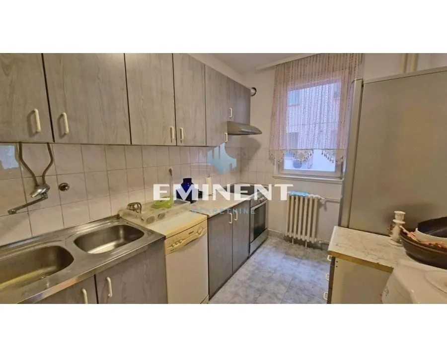 Smaller kitchen with a sink, cabinetry, and a window.