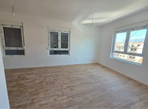 Empty room with parquet flooring and white walls. - image 4