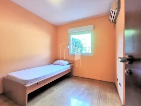Small bedroom with a bed and orange walls. - image 10