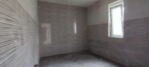 Renovated bathroom with installed tiles and a window. - image 5