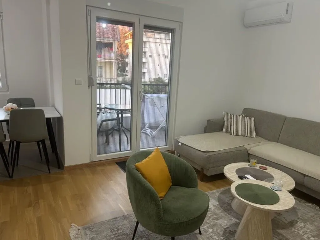 Living room with sofa, armchair and dining area.