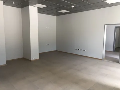 Empty interior space with tiled floor and suspended ceiling. - image 2