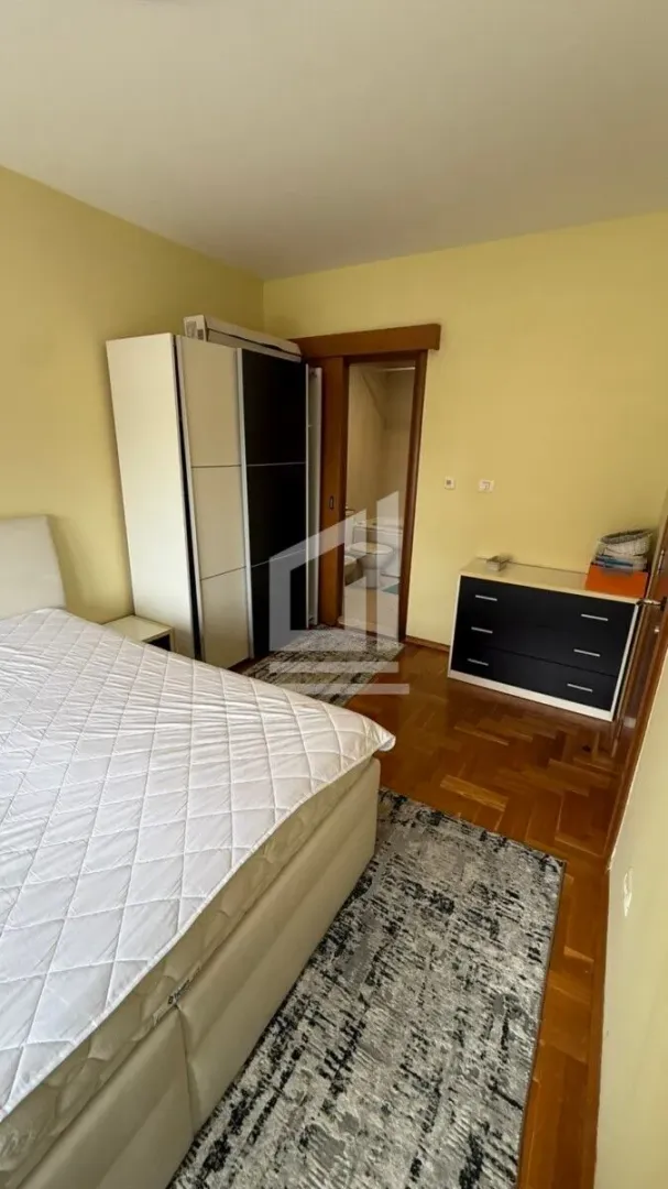 Bedroom with a double bed, wardrobe, and chest of drawers.