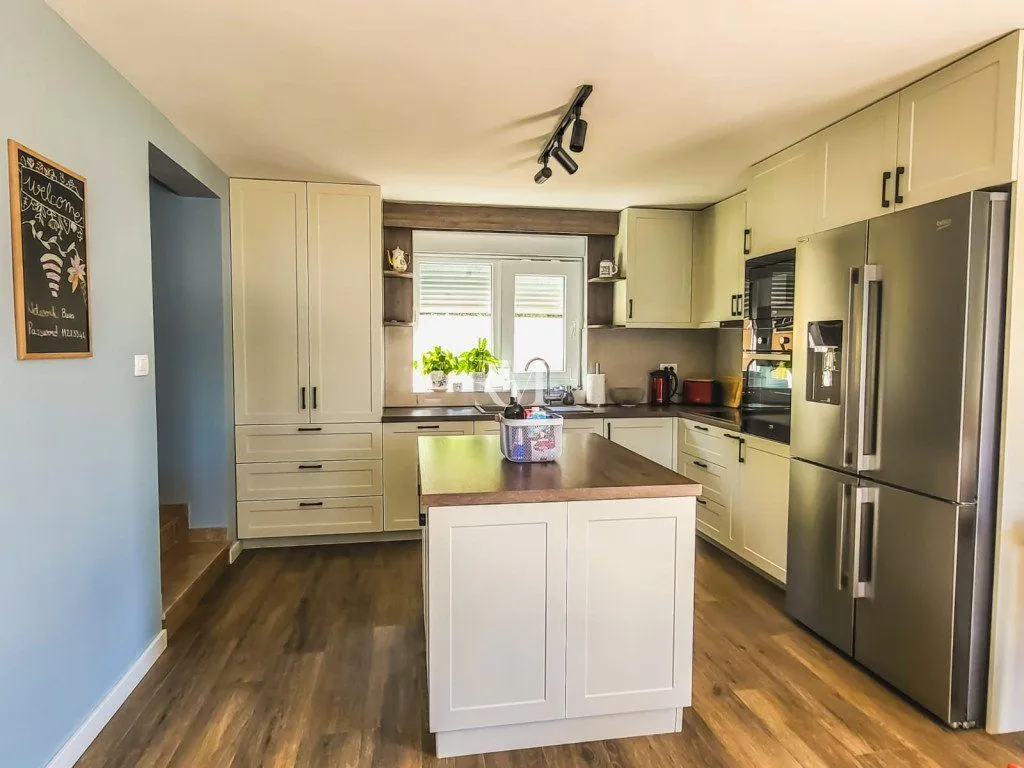 Modern and equipped kitchen with wooden elements and an island.