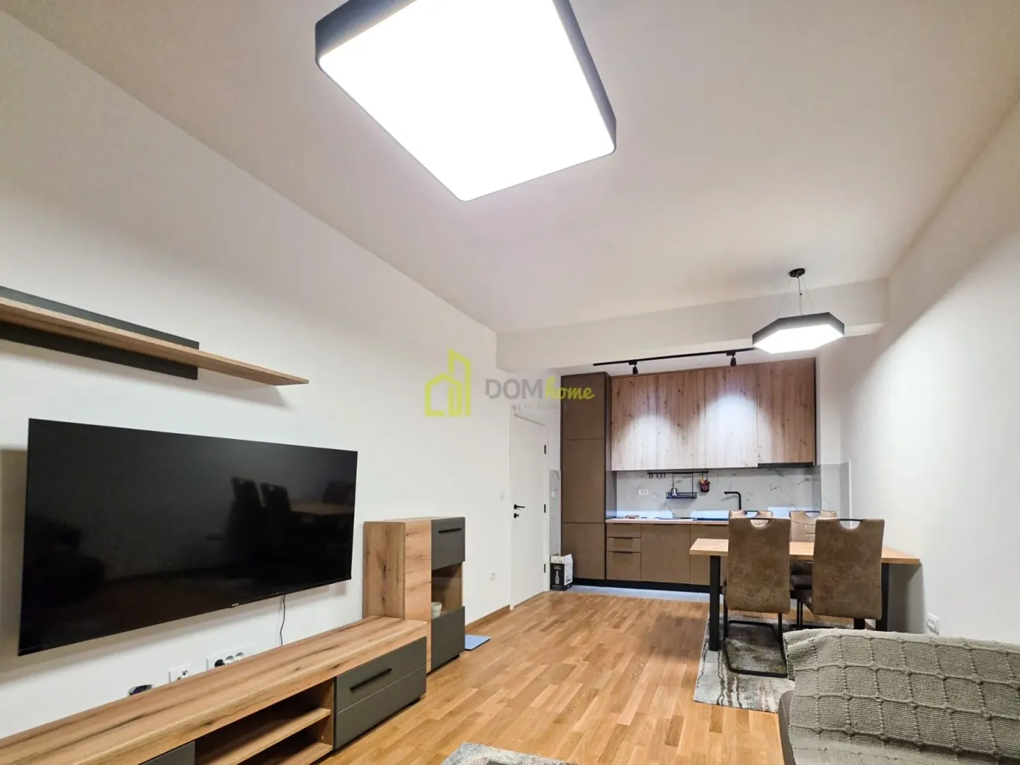 Living room with a dining area and kitchen in the background.