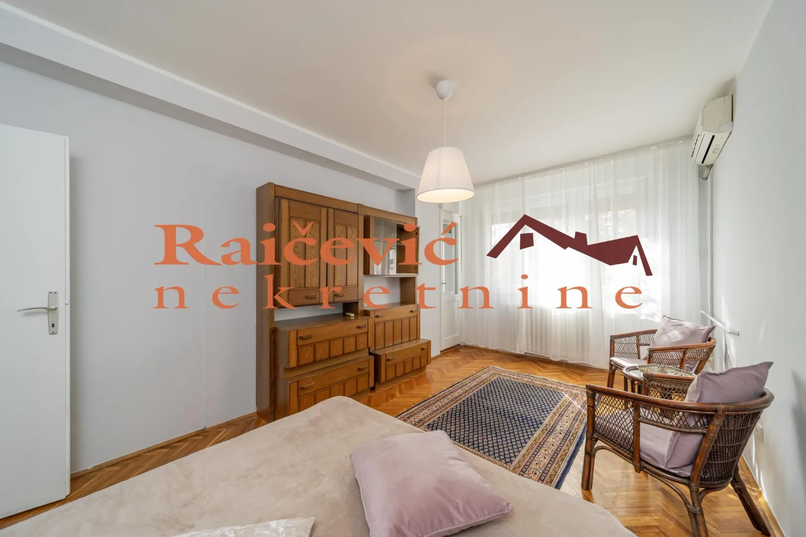 Living room with wooden furniture, a rug, and seating.