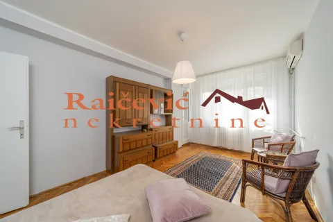Living room with wooden furniture, a rug, and seating. - image 11