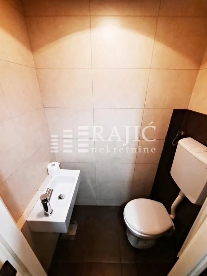 Small bathroom with toilet and sink.