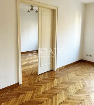Empty room with wooden parquet flooring and an open door. - image 3