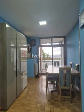 Dining area with a wooden table and chairs and access to the terrace. - image 18