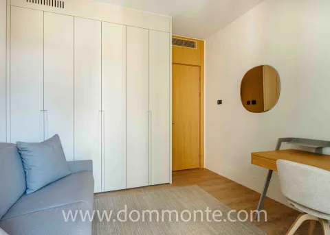 Modern bedroom with a built-in wardrobe, bed, and desk. - image 11
