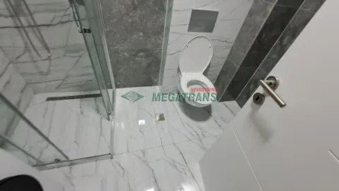 Savremeno opremljeno kupatilo sa tuš kabinom i belim keramičkim pločicama. - image 11