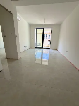 Empty bright room with ceramic floor tiles and balcony doors. - image 7