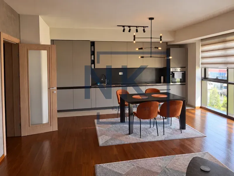 Modern kitchen with a dining area and built-in appliances.