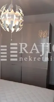 Bedroom with a wardrobe and a modern chandelier. - image 7