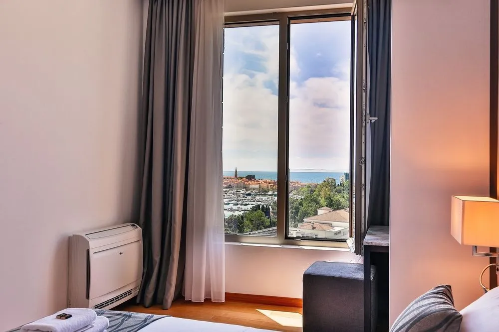 Bedroom with a large window and sea view.