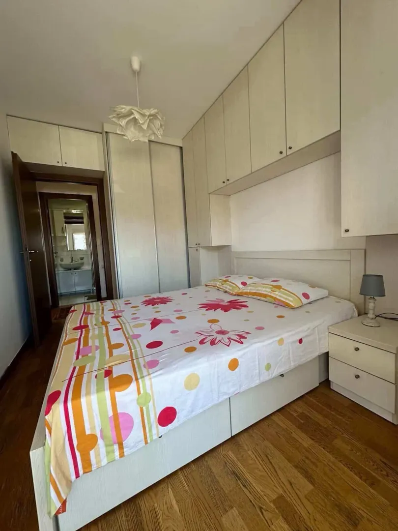 Furnished bedroom with a double bed and built-in wardrobes.