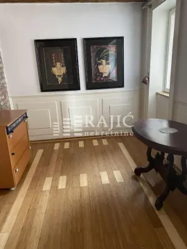 Living room with a dining table and wooden flooring. - image 18