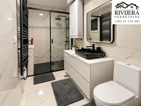 Modern bathroom with a walk-in shower, washbasin, and toilet. - image 11