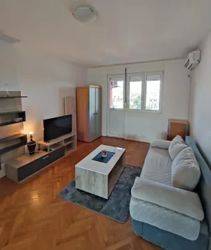 Living room with a sofa, TV, and access to the terrace. - image 10