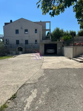 View of the courtyard and the house facade with a garage. - image 22