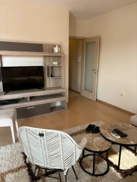 Living room with a TV unit, coffee table, and armchair. - image 3
