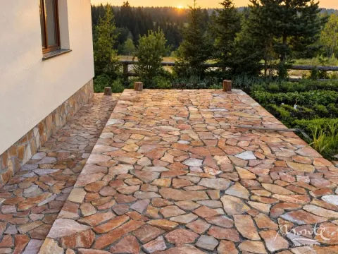 Paved terrace next to the house with a view of the forest in the background. - image 26